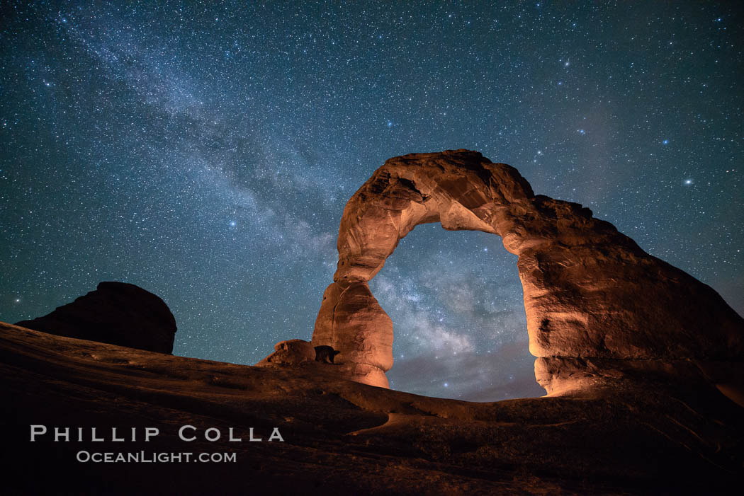 Milky Way and Stars over Delicate Arch, at night, Arches National Park, Utah (Note: this image was created before a ban on light-painting in Arches National Park was put into effect.  Light-painting is no longer permitted in Arches National Park). USA, natural history stock photograph, photo id 29294