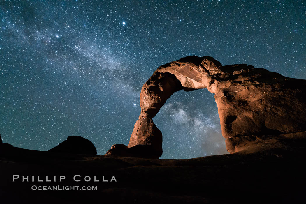 Milky Way and Stars over Delicate Arch, at night, Arches National Park, Utah (Note: this image was created before a ban on light-painting in Arches National Park was put into effect.  Light-painting is no longer permitted in Arches National Park). USA, natural history stock photograph, photo id 29297