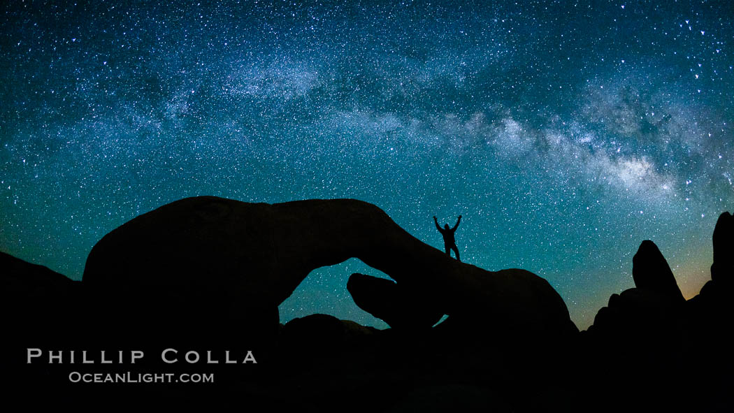 The Milky Way galaxy arches over Arch Rock on a clear evening in Joshua Tree National Park