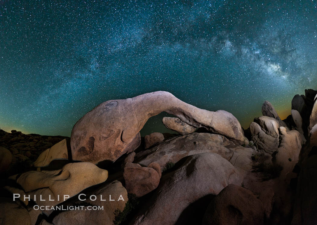 The Milky Way galaxy arches over Arch Rock on a clear evening in Joshua Tree National Park. California, USA, natural history stock photograph, photo id 26796