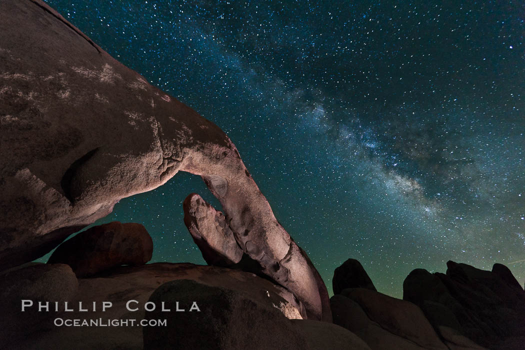The Milky Way galaxy arcs over Arch Rock on a clear evening in Joshua Tree National Park. California, USA, natural history stock photograph, photo id 26793