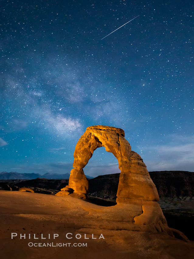 Milky Way and Shooting Star over Delicate Arch, as stars cover the night sky. Arches National Park, Utah, USA, natural history stock photograph, photo id 27854