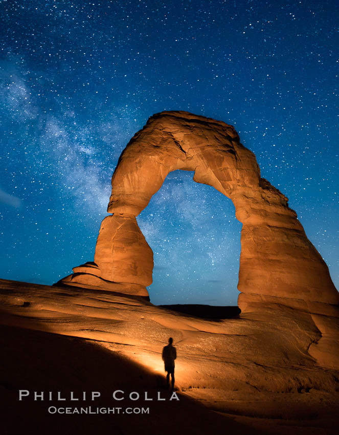 Milky Way arches over Delicate Arch, as stars cover the night sky. (Note: this image was created before a ban on light-painting in Arches National Park was put into effect.  Light-painting is no longer permitted in Arches National Park). Utah, USA, natural history stock photograph, photo id 27856