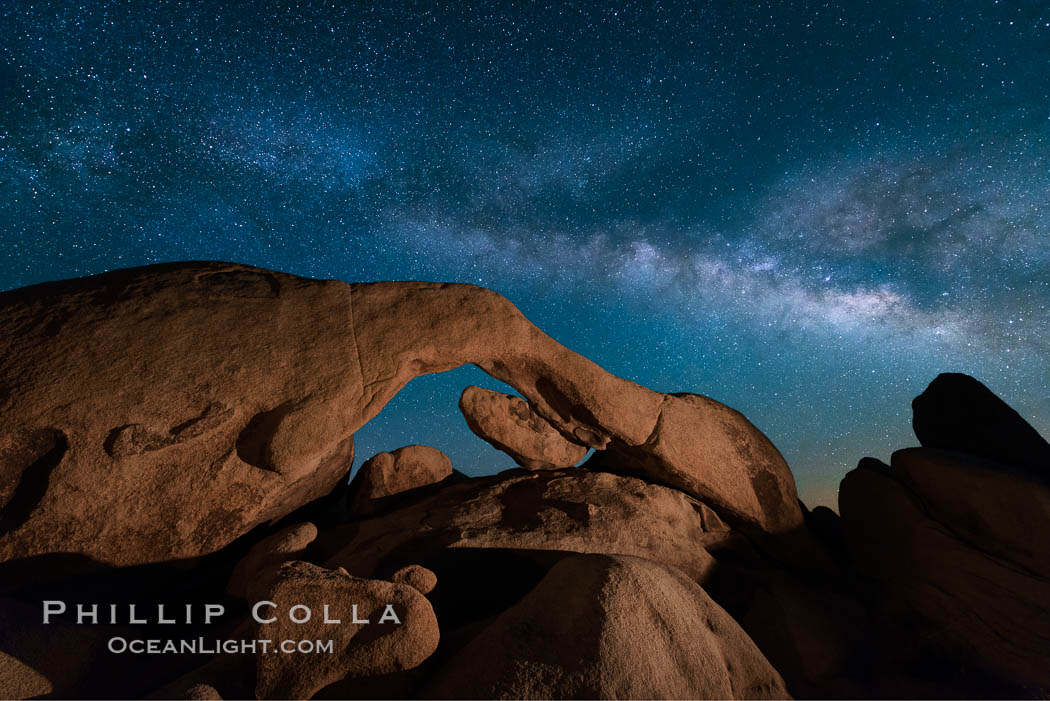 The Milky Way stretches across the sky above Arch Rock in Joshua Tree National Park. California, USA, natural history stock photograph, photo id 28407