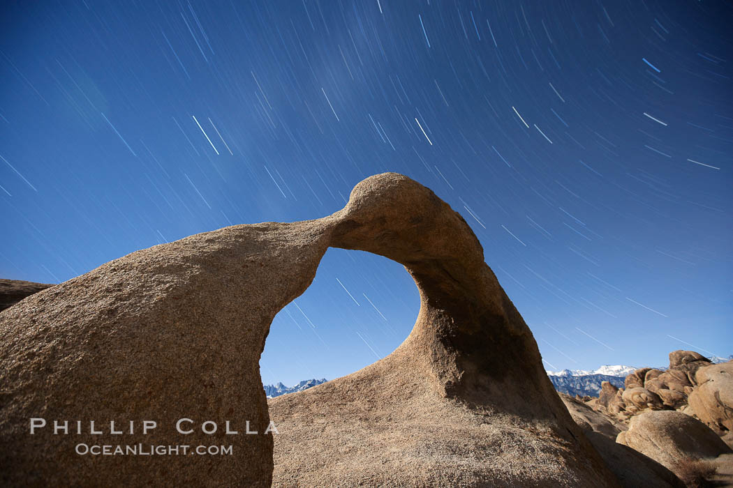 Mobius Arch in the Alabama Hills, seen here at night with swirling star trails formed in the sky above due to a long time exposure. Alabama Hills Recreational Area, California, USA, natural history stock photograph, photo id 21730