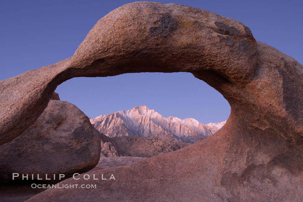 Mobius Arch at sunrise, framing snow dusted Lone Pine Peak and the Sierra Nevada Range in the background.  Also known as Galen's Arch, Mobius Arch is found in the Alabama Hills Recreational Area near Lone Pine. California, USA, natural history stock photograph, photo id 21766