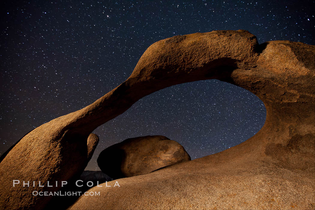Mobius Arch in the Alabama Hills, seen here at night with swirling star trails formed in the sky above due to a long time exposure. Alabama Hills Recreational Area, California, USA, natural history stock photograph, photo id 27675