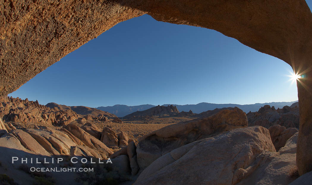 The Alabama Hills viewed through the natural stone arch of Mobius Arch, early morning. Alabama Hills Recreational Area, California, USA, natural history stock photograph, photo id 21741
