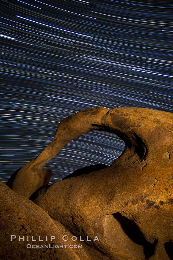 Mobius Arch in the Alabama Hills, seen here at night with swirling star trails formed in the sky above due to a long time exposure. Alabama Hills Recreational Area, California, USA, natural history stock photograph, photo id 27673