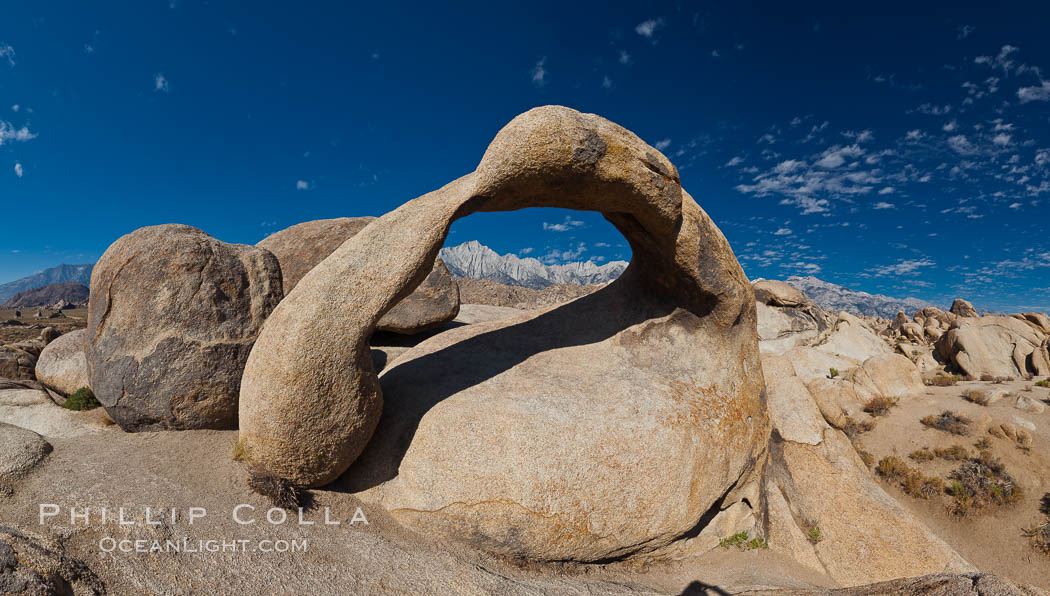 Mobius Arch panorama, with Mount Whitney (the tallest peak in the continental United States), Lone Pine Peak and Sierra Nevada Range framed within the arch. Mobius Arch is a 17-foot-wide natural rock arch in the scenic Alabama Hills Recreational Area near Lone Pine, California. USA, natural history stock photograph, photo id 26971