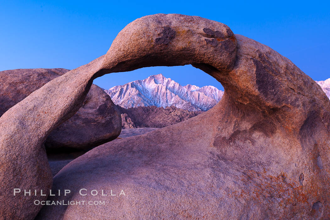 Mobius Arch at sunrise, framing snow dusted Lone Pine Peak and the Sierra Nevada Range in the background. Also known as Galen's Arch, Mobius Arch is found in the Alabama Hills Recreational Area near Lone Pine