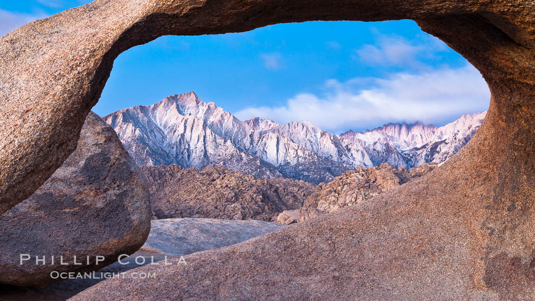 Mobius Arch at sunrise, framing snow dusted Lone Pine Peak and the Sierra Nevada Range in the background. Also known as Galen's Arch, Mobius Arch is found in the Alabama Hills Recreational Area near Lone Pine. California, USA, natural history stock photograph, photo id 27646