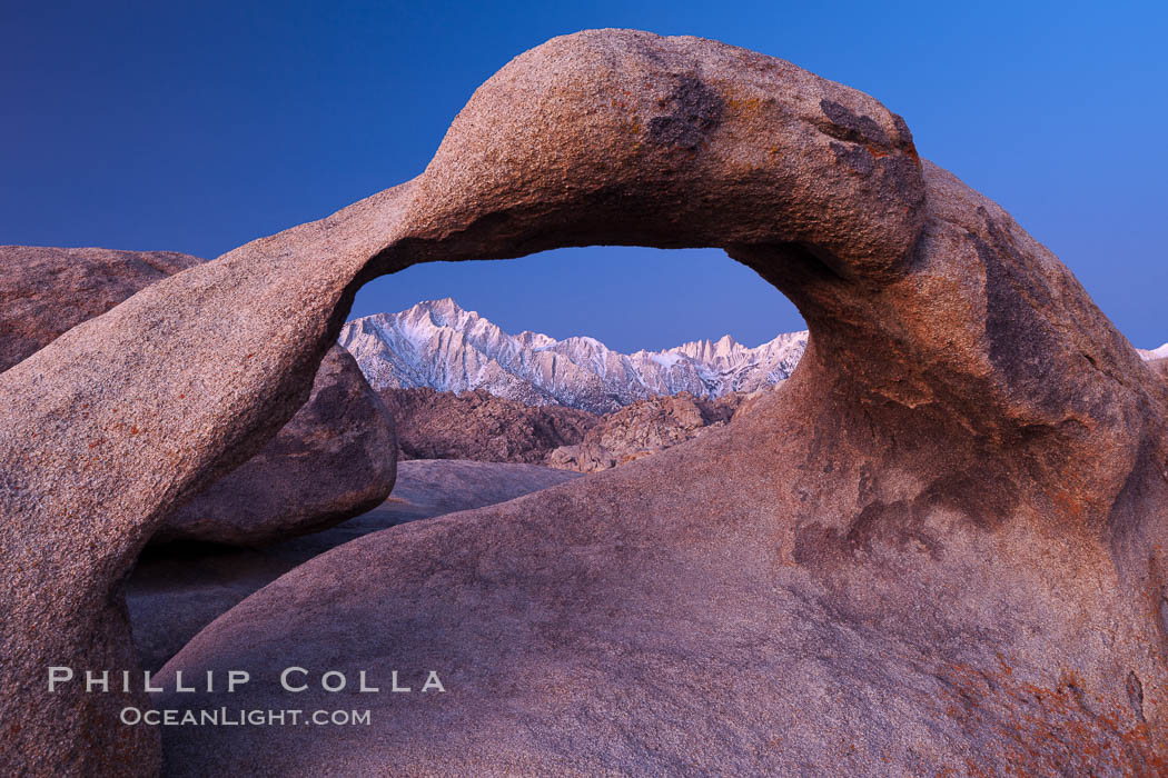 Mobius Arch at sunrise, framing snow dusted Lone Pine Peak and the Sierra Nevada Range in the background. Also known as Galen's Arch, Mobius Arch is found in the Alabama Hills Recreational Area near Lone Pine. California, USA, natural history stock photograph, photo id 27623