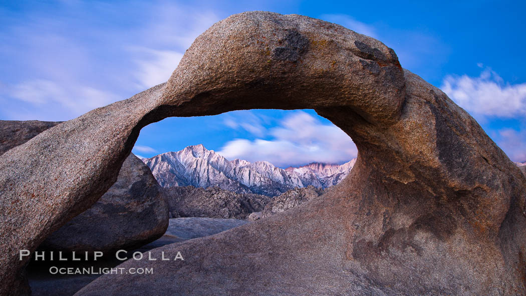 Mobius Arch at sunrise, framing snow dusted Lone Pine Peak and the Sierra Nevada Range in the background. Also known as Galen's Arch, Mobius Arch is found in the Alabama Hills Recreational Area near Lone Pine. California, USA, natural history stock photograph, photo id 27645