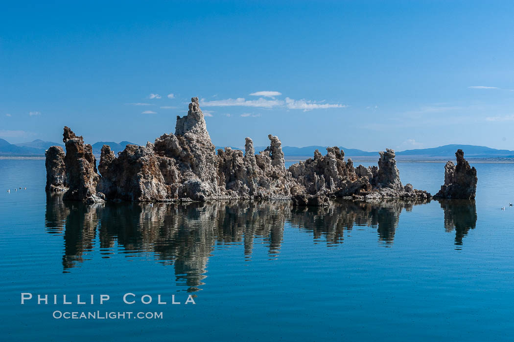 Tufa towers rise from Mono Lake. Tufa towers are formed when underwater springs rich in calcium mix with lakewater rich in carbonates, forming calcium carbonate (limestone) structures below the surface of the lake. The towers were eventually revealed when the water level in the lake was lowered starting in 1941. South tufa grove, Navy Beach