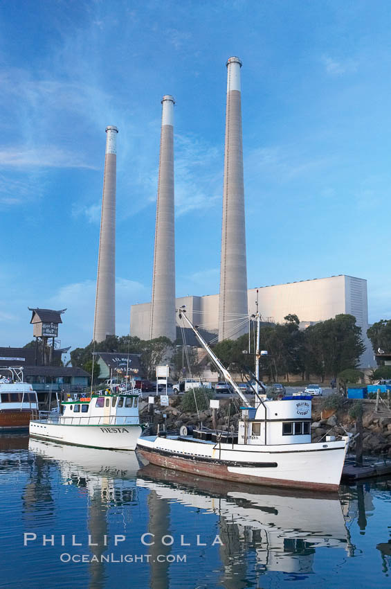 The Morro Bay Power Plant, with its distinctive three stacks, rises above fishing boats in Morro Bay harbor.  Morro Bay. California, USA, natural history stock photograph, photo id 14900