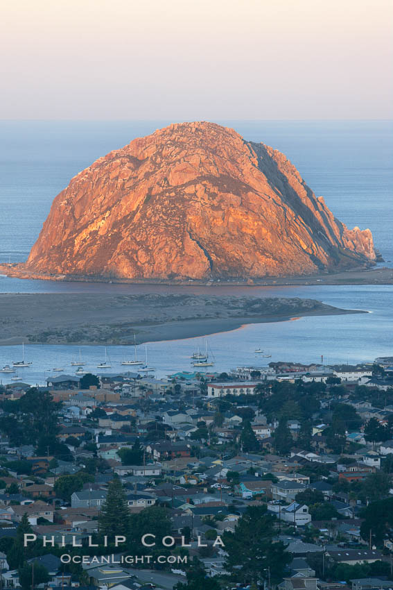 Morro Rock lit at sunrise, rises above Morro Bay which is still in early morning shadow. California, USA, natural history stock photograph, photo id 22218