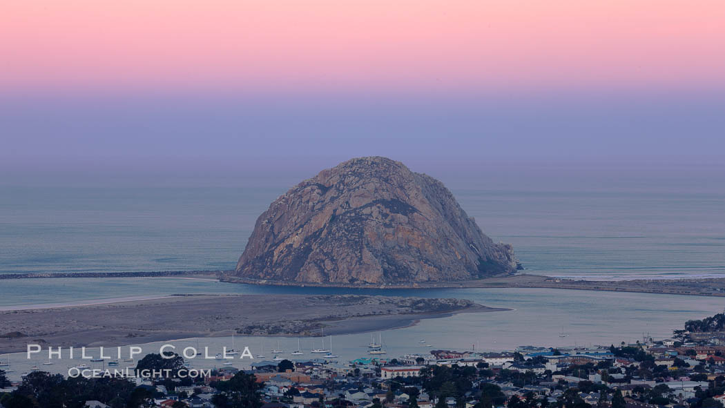 Earth shadow over Morro Rock and Morro Bay. Just before sunrise the shadow of the Earth can seen as the darker sky below the pink sunrise