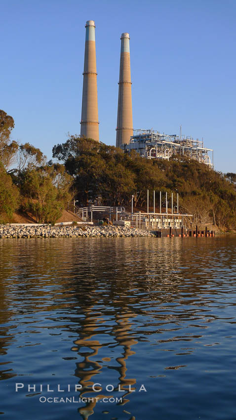 Moss Landing Power Plant rise above Moss Landing harbor and Elkhorn Slough.  The Moss Landing Power Plant is an electricity generation plant at Moss Landing, California.  The twin stacks, each 500 feet high, mark two generation units product 750 megawatts each. USA, natural history stock photograph, photo id 21497