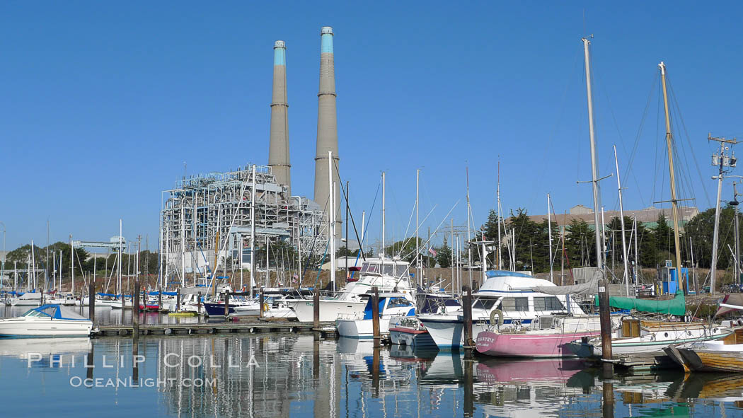 Moss Landing Power Plant rise above Moss Landing harbor and Elkhorn Slough.  The Moss Landing Power Plant is an electricity generation plant at Moss Landing, California.  The twin stacks, each 500 feet high, mark two generation units product 750 megawatts each., natural history stock photograph, photo id 21505