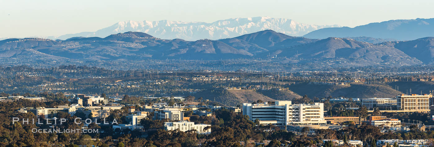 Snow-covered Mount San Gorgonio, seen beyond Double Peak Park in San Marcos, viewed from Mount Soledad in La Jolla, on an exceptionally clear winter day. Double Peak is about 20 miles away while the San Bernardino Mountains are about 90 miles distant. In the foreground are UCSD (University of California at San Diego, left), Veterans Administration Hospital (center) and Scripps La Jolla Medical Center (right)., natural history stock photograph, photo id 37589