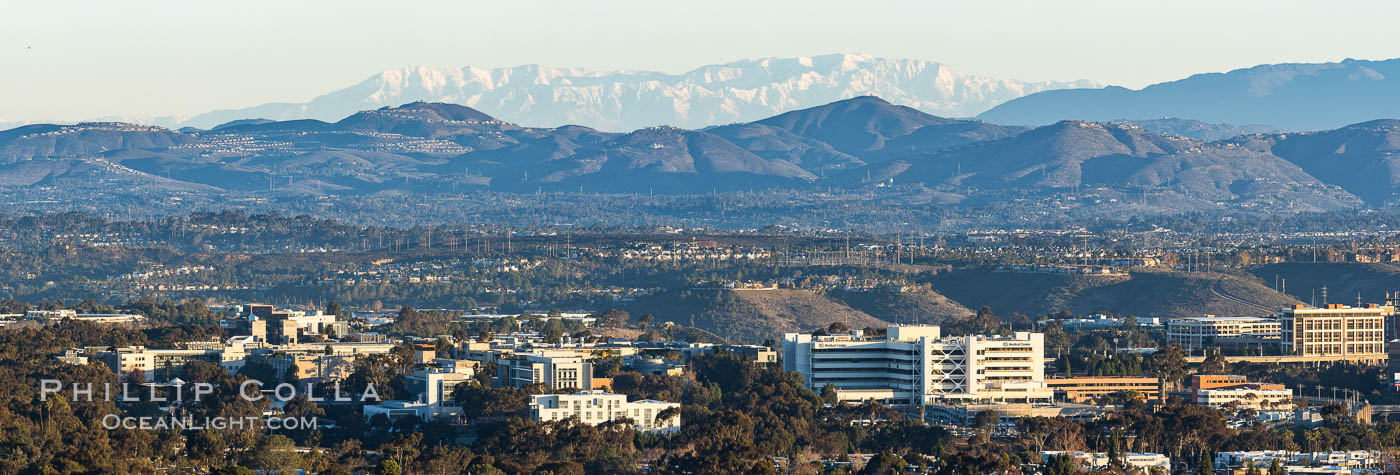 Snow-covered Mount San Gorgonio, seen beyond Double Peak Park in San Marcos, viewed from Mount Soledad in La Jolla, on an exceptionally clear winter day. Double Peak is about 20 miles away while the San Bernardino Mountains are about 90 miles distant. In the foreground are UCSD (University of California at San Diego, left), Veterans Administration Hospital (center) and Scripps La Jolla Medical Center (right)., natural history stock photograph, photo id 37589
