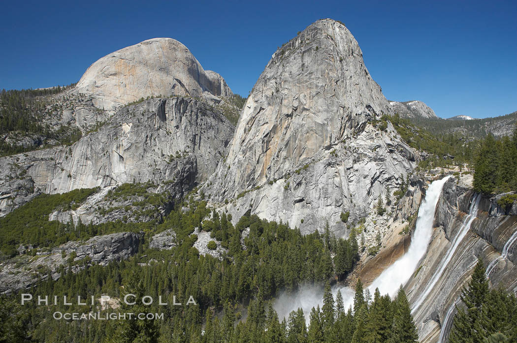 Nevada Falls, with Liberty Cap (center) and Half Dome (left). Nevada Falls marks where the Merced River plummets almost 600 through a joint in the Little Yosemite Valley, shooting out from a sheer granite cliff and then down to a boulder pile far below, Yosemite National Park, California