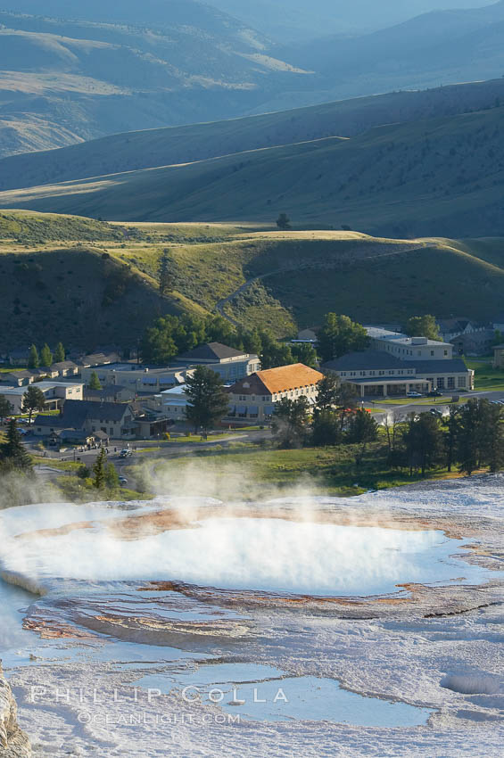 New Blue Spring steams in the cold morning air with Mammoth Hot Springs Inn in the distance. Yellowstone National Park, Wyoming, USA, natural history stock photograph, photo id 13611