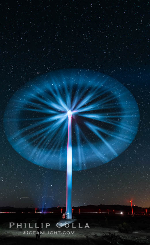 Stars rise above the Ocotillo Wind Turbine power generation facility, with a flashlight illuminating the turning turbine blades. California, USA, natural history stock photograph, photo id 30230
