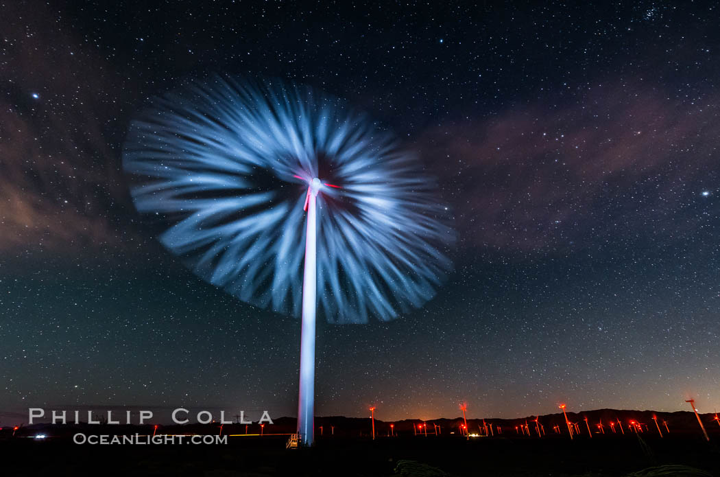 Stars rise above the Ocotillo Wind Turbine power generation facility, with a flashlight illuminating the turning turbine blades. California, USA, natural history stock photograph, photo id 30225