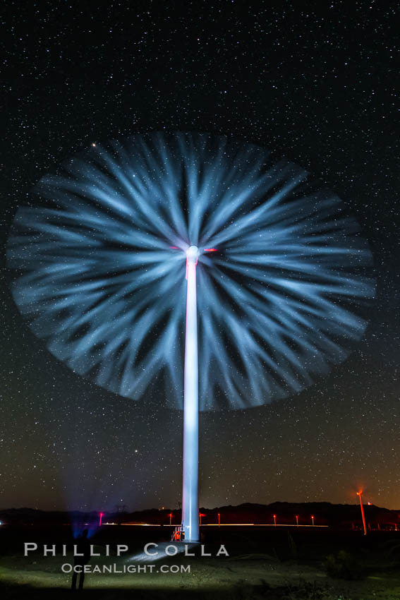 Stars rise above the Ocotillo Wind Turbine power generation facility, with a flashlight illuminating the turning turbine blades. California, USA, natural history stock photograph, photo id 30229