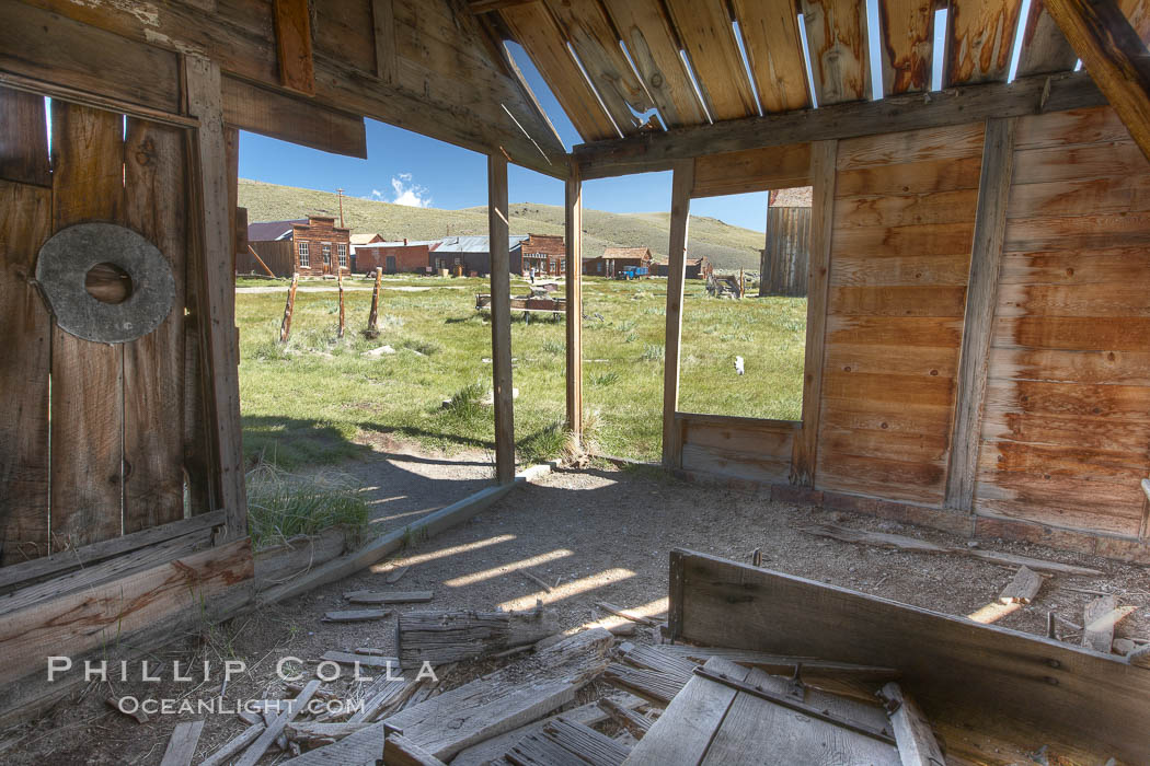 Old barn, interior with Main Street buildings in background. Bodie State Historical Park, California, USA, natural history stock photograph, photo id 23124