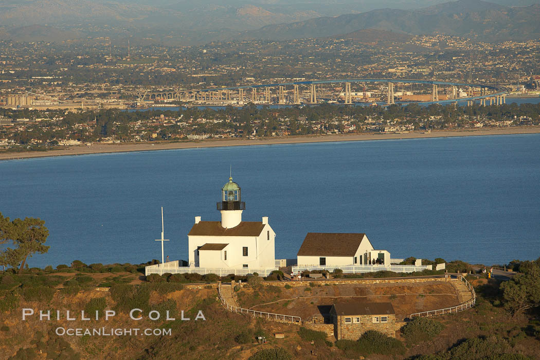 Old Point Loma Lighthouse, sitting high atop the end of Point Loma peninsula, seen here with San Diego Bay and downtown San Diego in the distance.  The old Point Loma lighthouse operated from 1855 to 1891 above the entrance to San Diego Bay. It is now a maintained by the National Park Service and is part of Cabrillo National Monument. California, USA, natural history stock photograph, photo id 22352