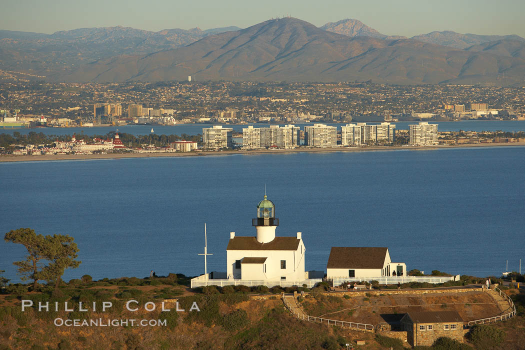 Old Point Loma Lighthouse, sitting high atop the end of Point Loma peninsula, seen here with San Diego Bay and downtown San Diego in the distance. The old Point Loma lighthouse operated from 1855 to 1891 above the entrance to San Diego Bay. It is now a maintained by the National Park Service and is part of Cabrillo National Monument