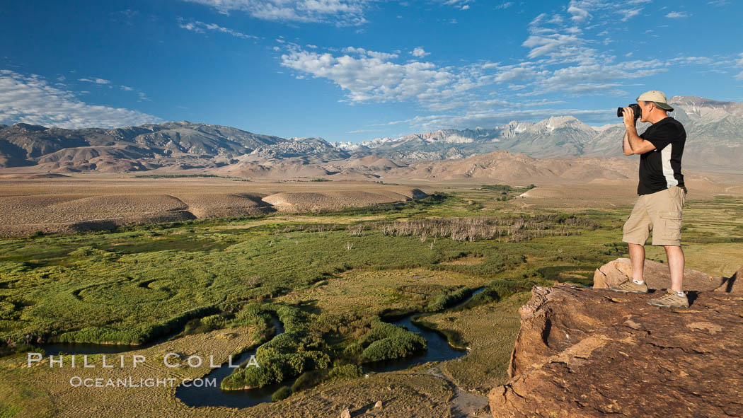 Photographer over Owens River valley, Sierra Nevada mountain range in distance, viewed from Volcanic Tablelands near Bishop, California. USA, natural history stock photograph, photo id 26985