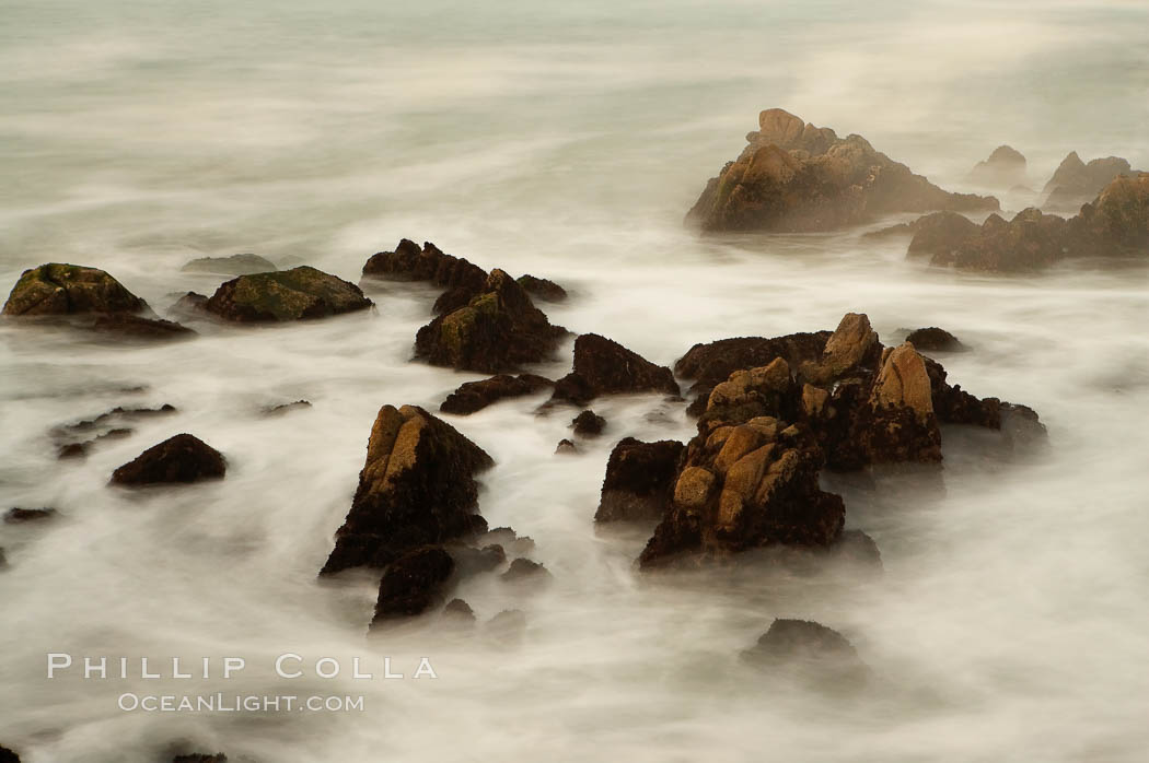 Waves breaking over rocks appear as a foggy mist in this time exposure.  Pacific Grove, Lovers Point