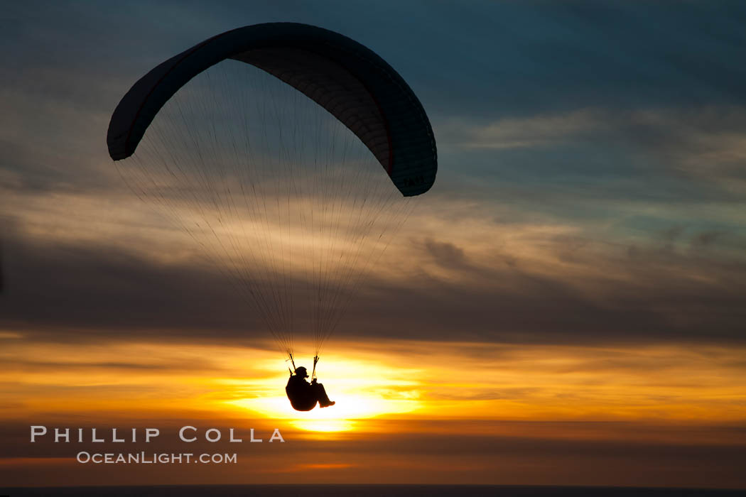 Paraglider soaring at Torrey Pines Gliderport, sunset, flying over the Pacific Ocean, La Jolla, California