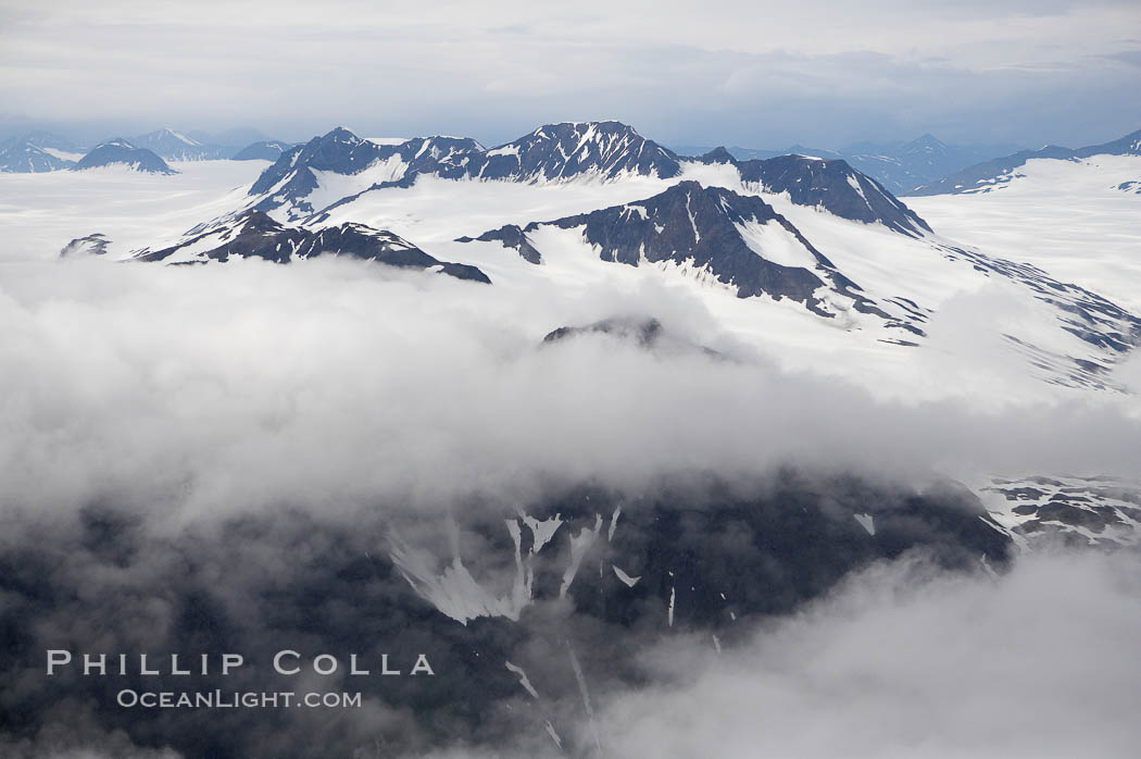 The Kenai Mountains rise above thick ice sheets and the Harding Icefield which is one of the largest icefields in Alaska and gives rise to over 30 glaciers. Kenai Fjords National Park, USA, natural history stock photograph, photo id 19042
