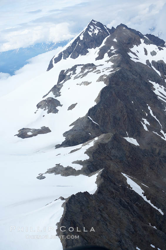 The Kenai Mountains rise above thick ice sheets and the Harding Icefield which is one of the largest icefields in Alaska and gives rise to over 30 glaciers. Kenai Fjords National Park, USA, natural history stock photograph, photo id 19020