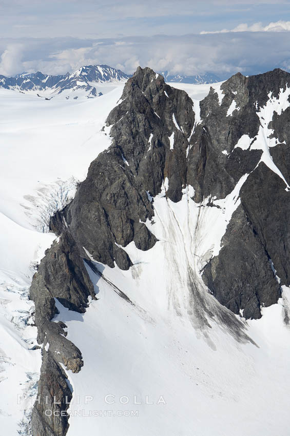 The Kenai Mountains rise above thick ice sheets and the Harding Icefield which is one of the largest icefields in Alaska and gives rise to over 30 glaciers. Kenai Fjords National Park, USA, natural history stock photograph, photo id 19040