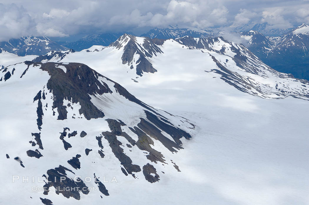 The Kenai Mountains rise above thick ice sheets and the Harding Icefield which is one of the largest icefields in Alaska and gives rise to over 30 glaciers. Kenai Fjords National Park, USA, natural history stock photograph, photo id 19048