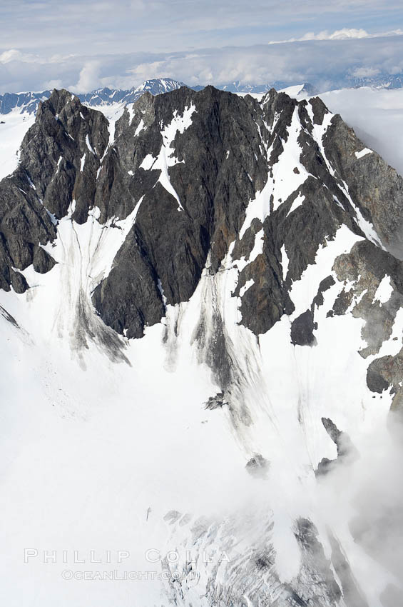 The Kenai Mountains rise above thick ice sheets and the Harding Icefield which is one of the largest icefields in Alaska and gives rise to over 30 glaciers. Kenai Fjords National Park, USA, natural history stock photograph, photo id 19023