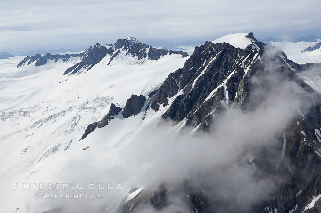 The Kenai Mountains rise above thick ice sheets and the Harding Icefield which is one of the largest icefields in Alaska and gives rise to over 30 glaciers. Kenai Fjords National Park, USA, natural history stock photograph, photo id 19031