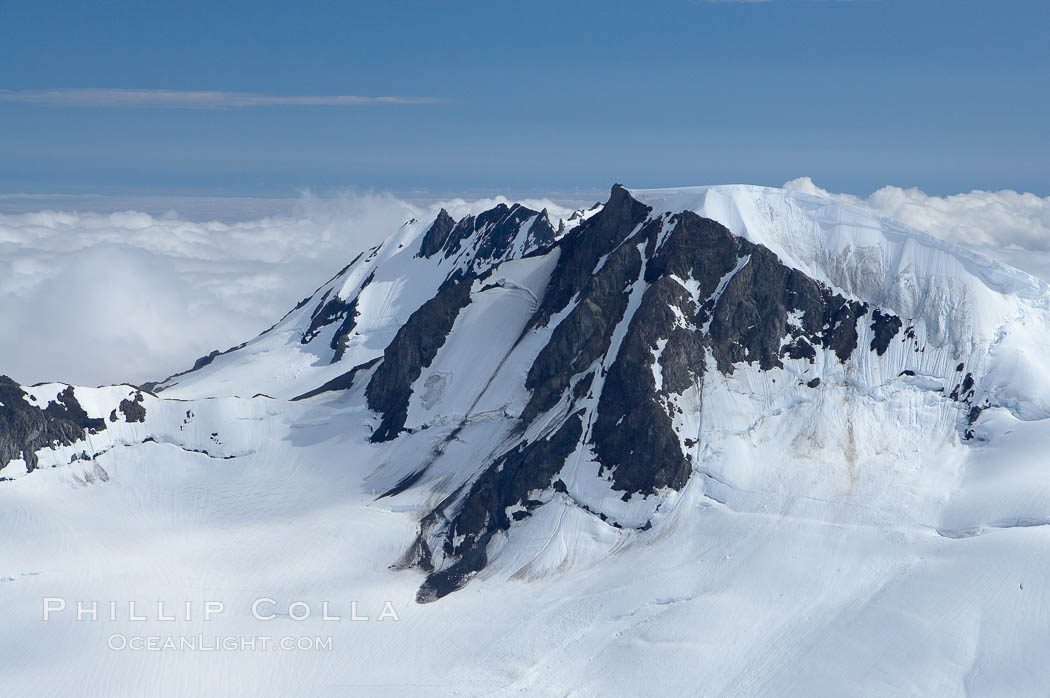 The Kenai Mountains rise above thick ice sheets and the Harding Icefield which is one of the largest icefields in Alaska and gives rise to over 30 glaciers. Kenai Fjords National Park, USA, natural history stock photograph, photo id 19047