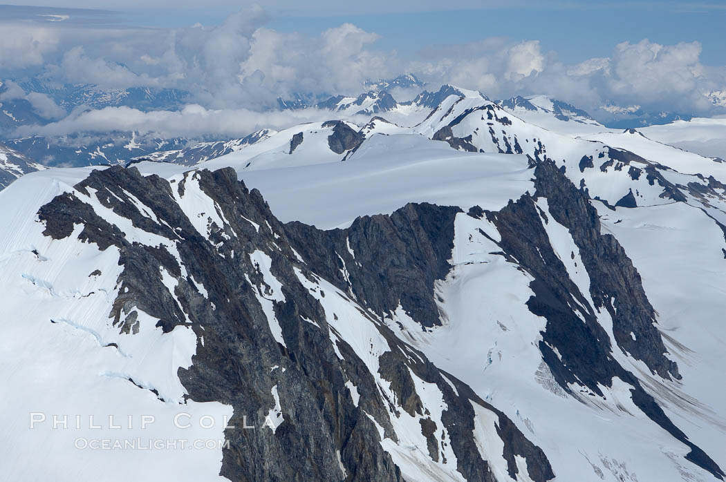 The Kenai Mountains rise above thick ice sheets and the Harding Icefield which is one of the largest icefields in Alaska and gives rise to over 30 glaciers. Kenai Fjords National Park, USA, natural history stock photograph, photo id 19033