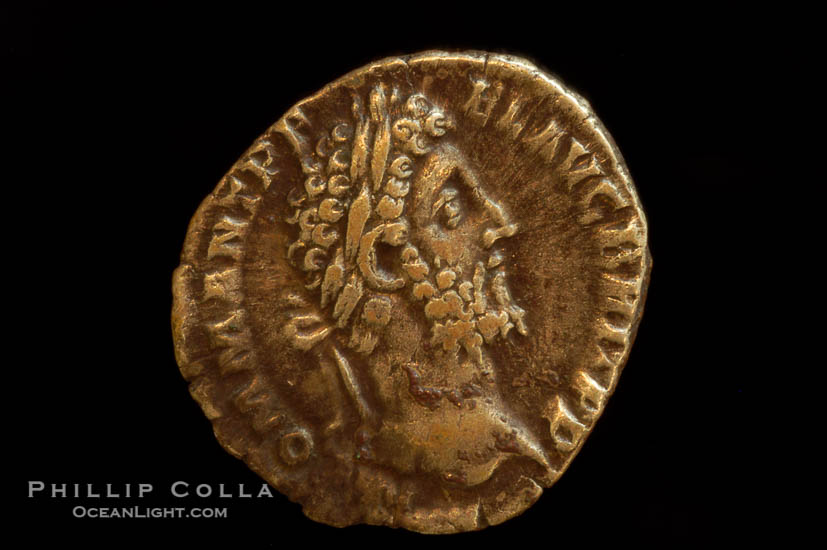 Roman emperor Commodus (177-192 A.D.), depicted on ancient Roman coin (silver, denom/type: Denarius) (AR , Denarius Obverse: M.COMM.ANT.P.FEL.AVG.BRIT.PP. Reverse: GEN.AVG.FLIC.COS.VI.  Genius standing left sacrificing scepter from a patera over an alter.)., natural history stock photograph, photo id 06796