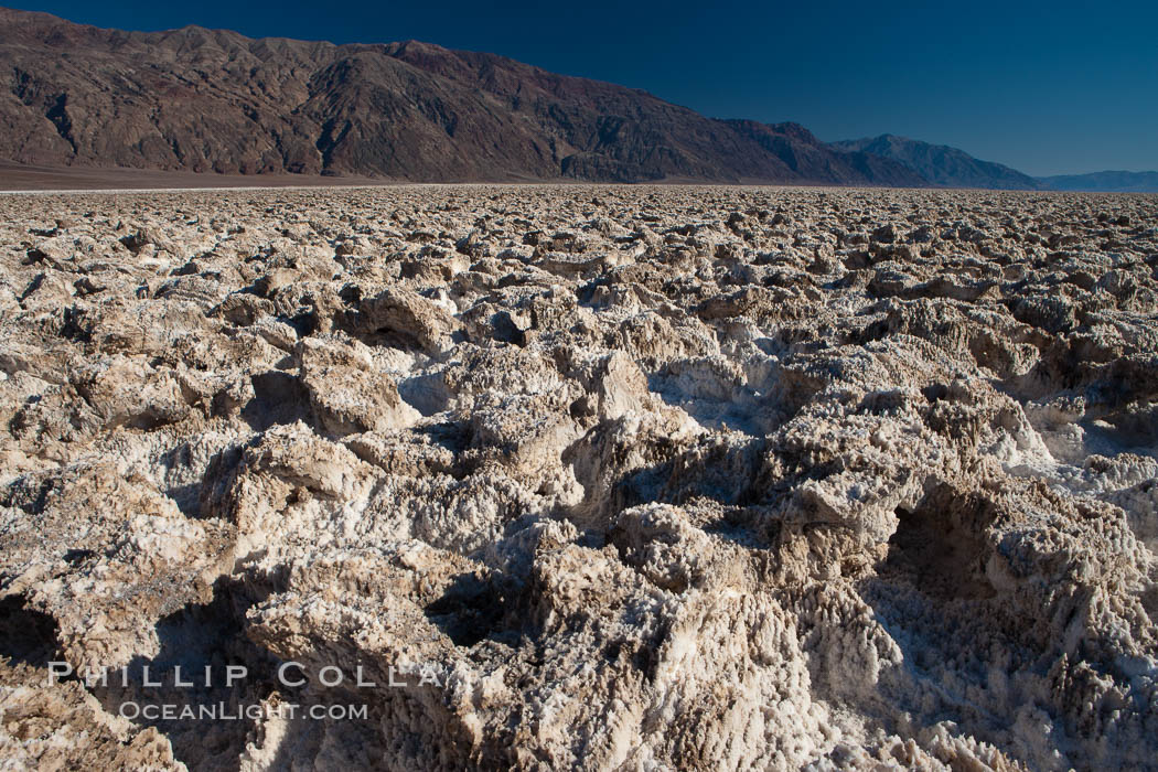 Devils Golf Course, California. Evaporated salt has formed into gnarled, complex crystalline shapes in on the salt pan of Death Valley National Park, one of the largest salt pans in the world. The shapes are constantly evolving as occasional floods submerge the salt concretions before receding and depositing more salt