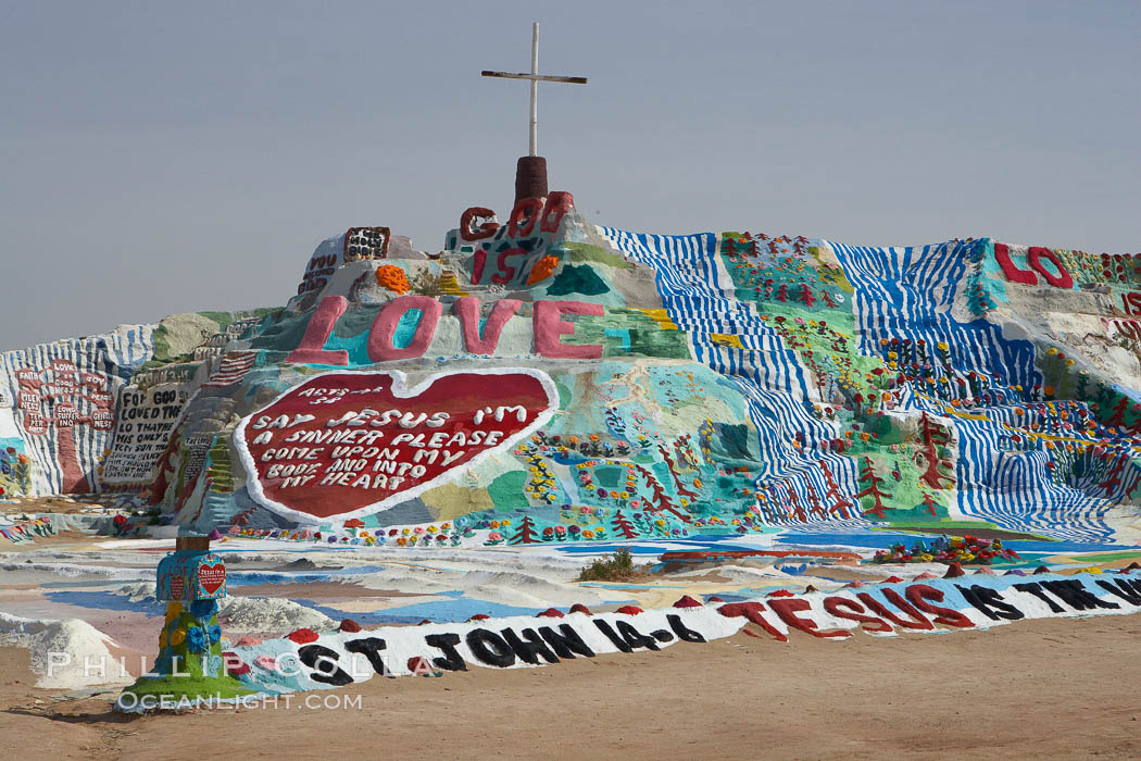 Salvation Mountain, near the desert community of Slab City and the small town of Niland on the east side of the Salton Sea.  Built over several decades by full-time resident Leonard Knight, who lives at the site, Salvation Mountain was built from over 100,000 gallons of paint, haybales, wood and metal and was created by Mr. Knight to convey the message that "God Loves Everyone". California, USA, natural history stock photograph, photo id 22504