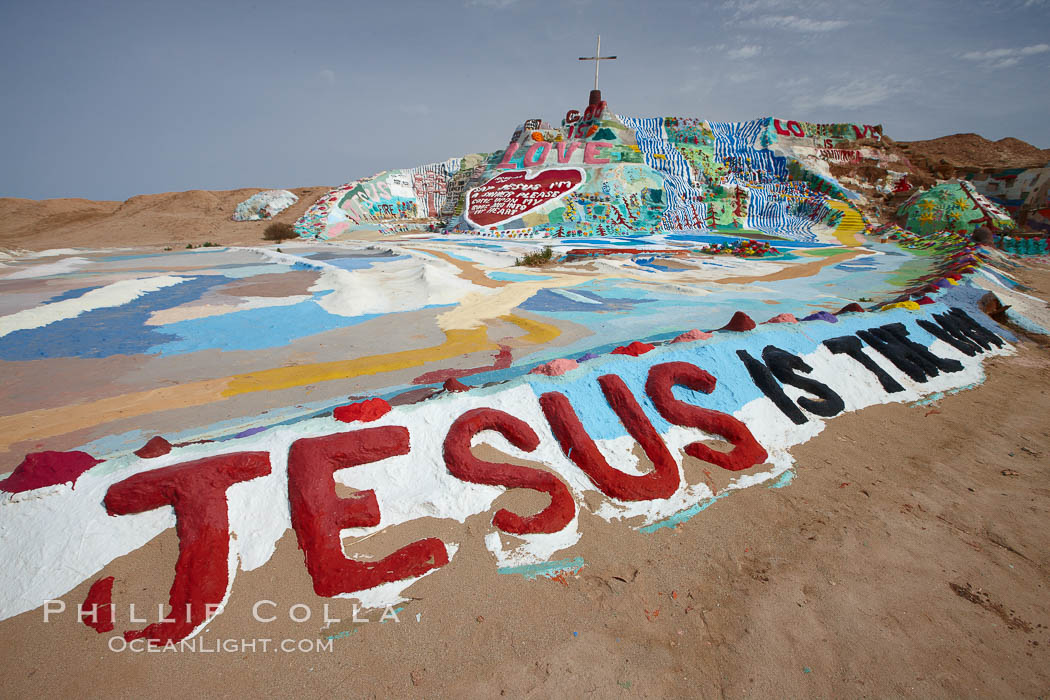 Salvation Mountain, near the desert community of Slab City and the small town of Niland on the east side of the Salton Sea.  Built over several decades by full-time resident Leonard Knight, who lives at the site, Salvation Mountain was built from over 100,000 gallons of paint, haybales, wood and metal and was created by Mr. Knight to convey the message that "God Loves Everyone". California, USA, natural history stock photograph, photo id 22513