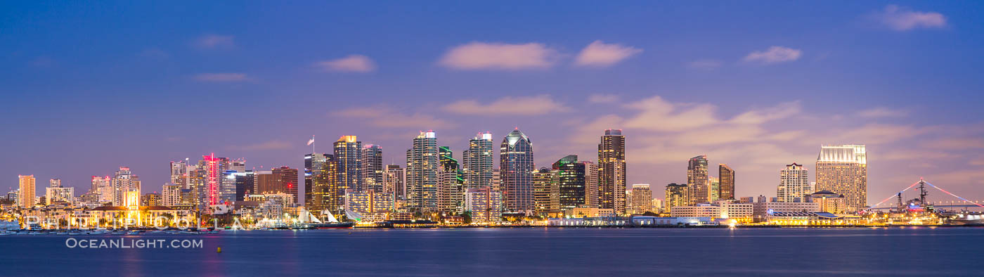 San Diego city skyline at sunset, showing the buildings of downtown San Diego rising above San Diego Harbor, viewed from Harbor Island